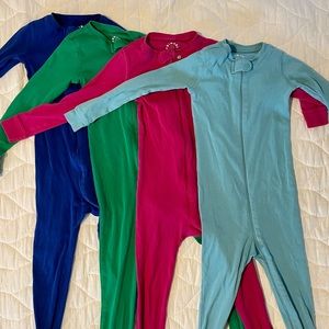 Four unisex sets of footie pajamas